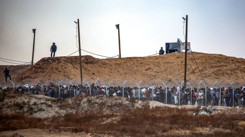 Members of Gaza Humanitarian Foundation (GHF), a private US-backed aid group which the UN refuses to work with over neutrality concerns, direct displaced Palestinians at a distribution centre in central Gaza on June 8.