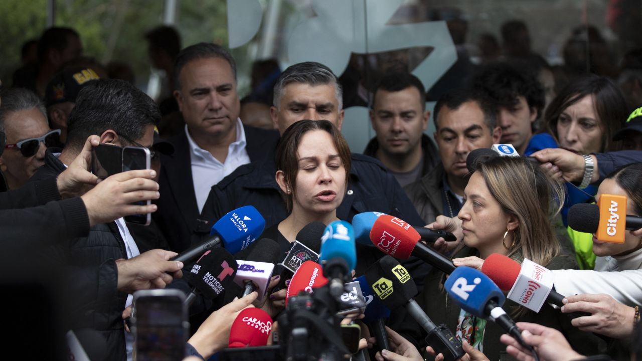 Maria Claudia Tarazona (C), wife of Colombian presidential candidate Miguel Uribe, speaks to the media outside the Fundacion Santa Fe clinic, where her husband is hospitalized after being shot in Bogota on June 8, 2025. A prominent Colombian right-wing presidential candidate who was shot during a campaign event in Bogota has successfully undergone initial surgery, the city's mayor said Sunday. Thirty-nine-year-old Senator Miguel Uribe was speaking to ers in the capital when a gunman shot him twice in the head and once in the knee before being detained. (Photo by Alejandro MARTINEZ / AFP) (Photo by ALEJANDRO MARTINEZ/AFP via Getty Images)          