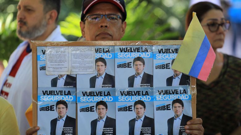 A man holds a sign with propaganda for presidential candidate Miguel Uribe during a protest against violence and in favor of peace in Medellin, Colombia, on June 8, 2025, the day after the attack on Uribe. A prominent Colombian right-wing presidential candidate who was shot during a campaign event in Bogota has successfully undergone initial surgery, the city's mayor said Sunday. Thirty-nine-year-old Senator Miguel Uribe was speaking to ers in the capital when a gunman shot him twice in the head and once in the knee before being detained. (Photo by JAIME SALDARRIAGA / AFP) (Photo by JAIME SALDARRIAGA/AFP via Getty Images)          