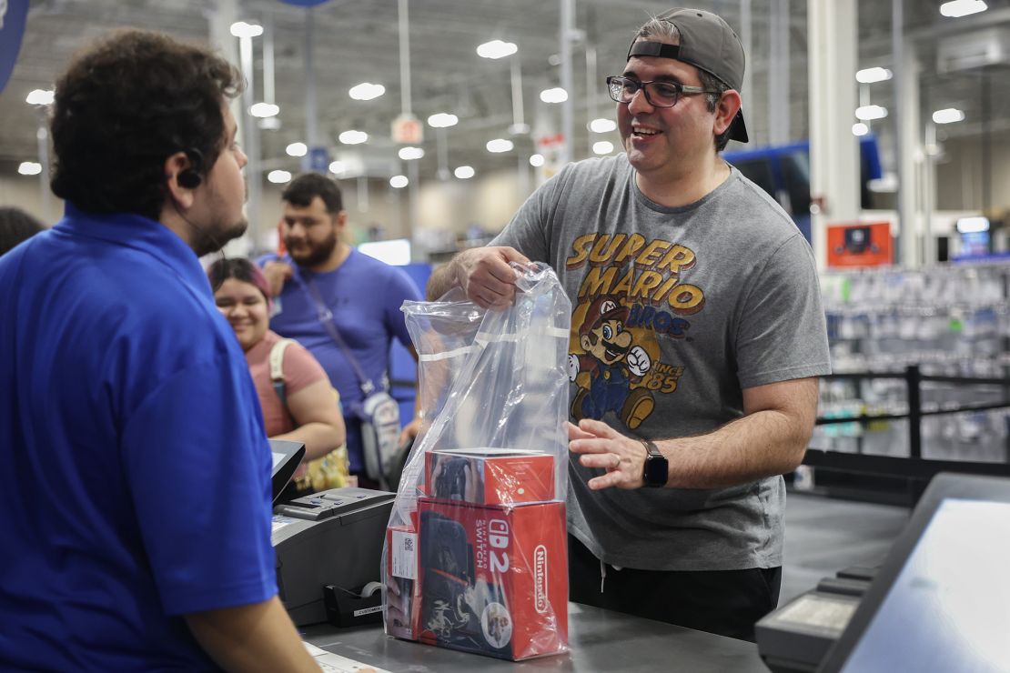 A customer purchases a Nintendo's Switch 2 console at a midnight opening of a Best Buy store today in Pembroke Pines, Florida.