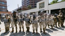 National Guard troops stand in front of a government building during a protest in Los Angeles, California, on June 8, 2025. Following a series of aggressive federal immigration operations in Los Angeles, tensions escalated when Immigration and Customs Enforcement (ICE) agents conducted a high-profile raid on a Home Depot location. The raid sparked widespread protests across the city, where demonstrators decried the targeting of immigrant communities and the separation of families. Clashes soon broke out between protesters and federal agents, prompting U.S. President Donald Trump to deploy 2,000 National Guard troops to the city, a move harshly criticized by California officials, including the governor, as "purposefully inflammatory." (Photo by David Pashaee / Middle East Images via AFP) (Photo by DAVID PASHAEE/Middle East Images/AFP via Getty Images)          