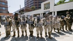 National Guard troops stand in front of a government building during a protest in Los Angeles, California, on June 8, 2025. Following a series of aggressive federal immigration operations in Los Angeles, tensions escalated when Immigration and Customs Enforcement (ICE) agents conducted a high-profile raid on a Home Depot location. The raid sparked widespread protests across the city, where demonstrators decried the targeting of immigrant communities and the separation of families. Clashes soon broke out between protesters and federal agents, prompting U.S. President Donald Trump to deploy 2,000 National Guard troops to the city, a move harshly criticized by California officials, including the governor, as "purposefully inflammatory." (Photo by David Pashaee / Middle East Images via AFP) (Photo by DAVID PASHAEE/Middle East Images/AFP via Getty Images)