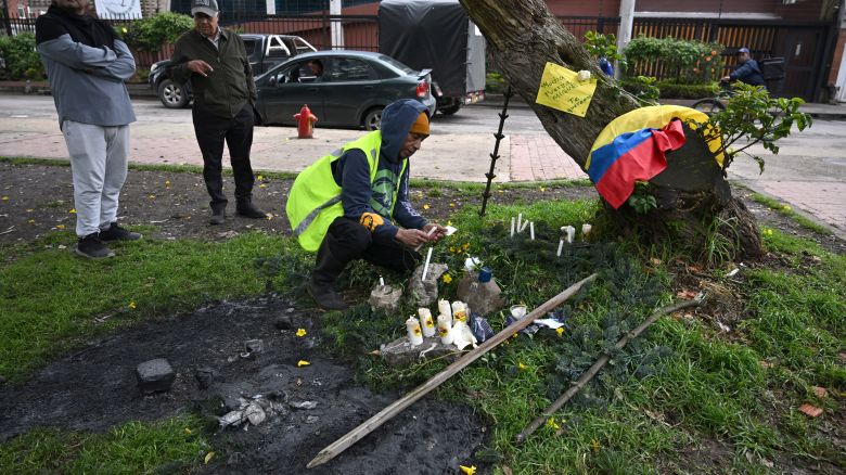 A man light candle in the place after the Senator Miguel Uribe Turbay was shot and wounded in a political event last Saturday in Bogota on June 9, 2025. Doctors treating a Colombian presidential hopeful shot twice in the head by a would-be assassin warned he was not responding well to treatment Monday and that his condition remained grave. (Photo by Raul ARBOLEDA / AFP) (Photo by RAUL ARBOLEDA/AFP via Getty Images)