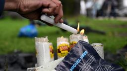 TOPSHOT - A person lights candle in the place after the Senator Miguel Uribe Turbay was shot and wounded in a political event last Saturday in Bogota on June 9, 2025. Doctors treating a Colombian presidential hopeful shot twice in the head by a would-be assassin warned he was not responding well to treatment Monday and that his condition remained grave. (Photo by Raul ARBOLEDA / AFP) (Photo by RAUL ARBOLEDA/AFP via Getty Images)