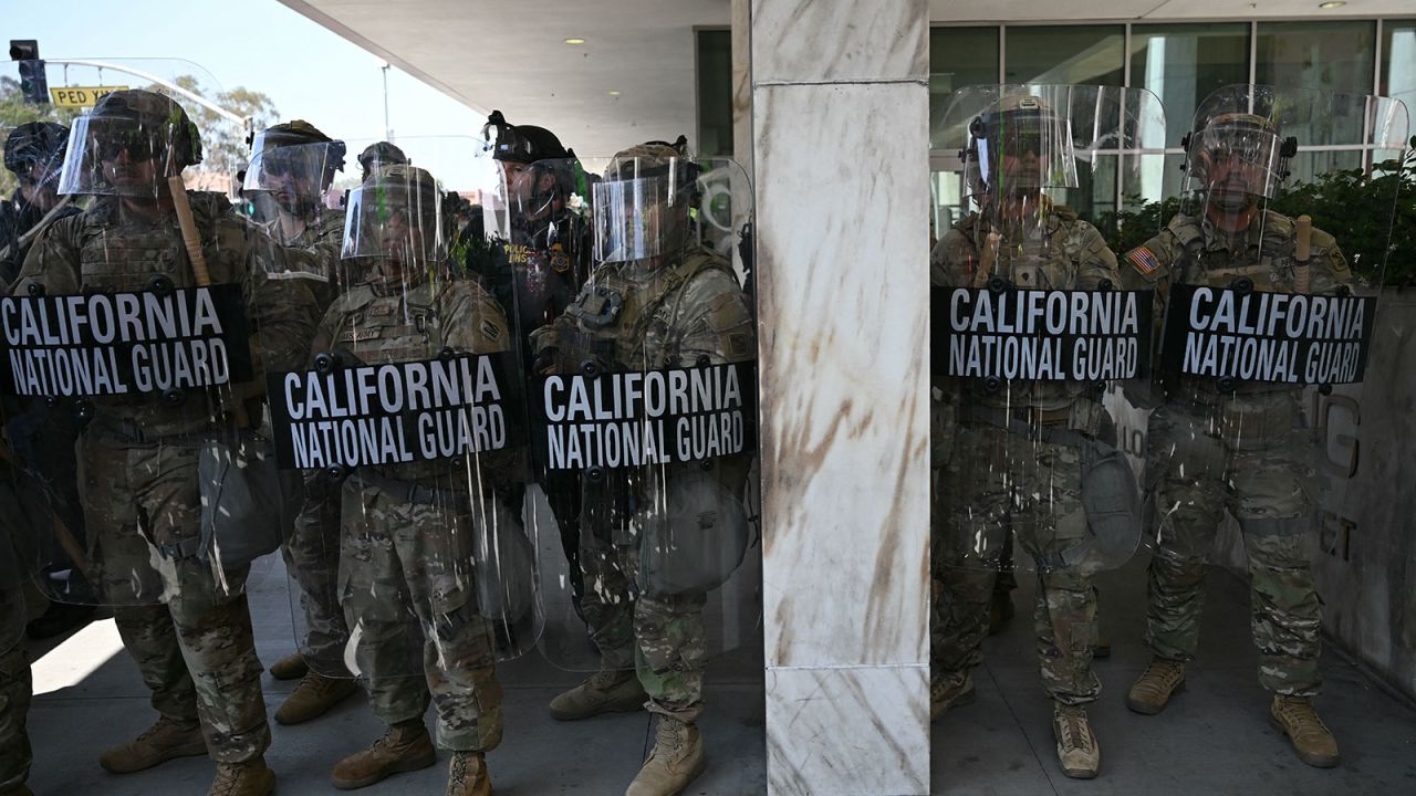 California National Guard members stand guard outside the Federal Building in Los Angeles, on Monday.