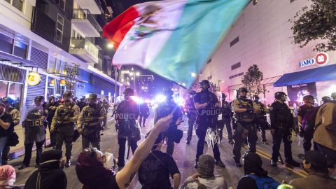 Demonstrators waving a Mexico flag, confront Police officers in riot gear during a demonstration following federal immigration operations in Los Angeles on June 9, 2025. President Donald Trump's istration said on June 9 that it was sending 700 US Marines and thousands more National Guard troops to Los Angeles, sparking a furious response from California's governor over the "deranged" deployment. Protests in Los Angeles, home to a large Latino population, broke out on June 6, triggered by immigration raids that resulted in dozens of arrests of what authorities say are illegal migrants and gang . (Photo by RINGO CHIU / AFP) (Photo by RINGO CHIU/AFP via Getty Images)          