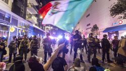 Demonstrators waving a Mexico flag, confront Police officers in riot gear during a demonstration following federal immigration operations in Los Angeles on June 9, 2025. President Donald Trump's istration said on June 9 that it was sending 700 US Marines and thousands more National Guard troops to Los Angeles, sparking a furious response from California's governor over the "deranged" deployment. Protests in Los Angeles, home to a large Latino population, broke out on June 6, triggered by immigration raids that resulted in dozens of arrests of what authorities say are illegal migrants and gang . (Photo by RINGO CHIU / AFP) (Photo by RINGO CHIU/AFP via Getty Images)