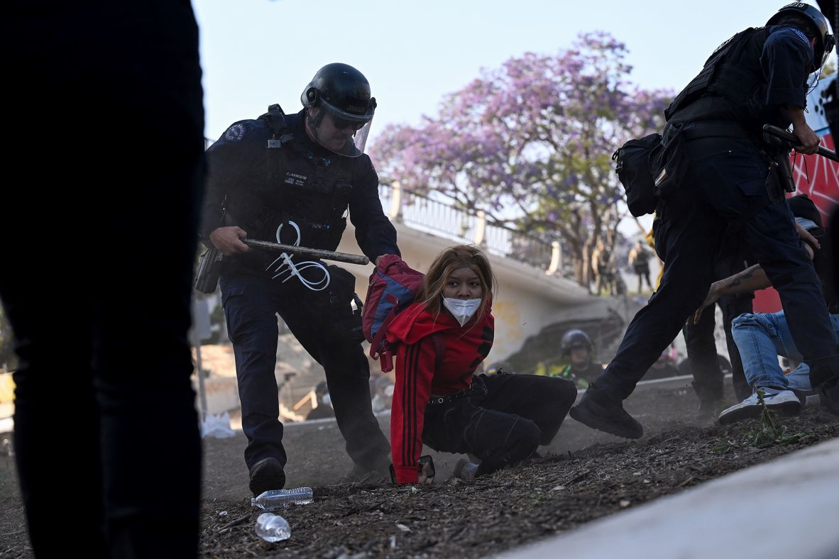 Protesters are rounded up by police officers outside the Metropolitan Detention Center in Los Angeles on Monday.