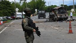 A police officer stands guard at the site where a bus exploded in front of a police station in Villa Rica, Cauca department, Colombia, on June 10, 2025. Southwest Colombia was rocked by a string of explosions and gun attacks that left at least three people dead Tuesday, police said, in what appeared to be a coordinated attack designed to sow terror. The attacks hit Cali -- the country's third largest city -- and several nearby towns, targeting police stations and other municipal buildings. (Photo by Joaquin Sarmiento / AFP) (Photo by JOAQUIN SARMIENTO/AFP via Getty Images)          