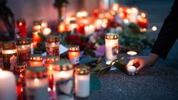 A woman leaves a candle at a makeshift memorial site near the school where several people died in a school shooting, on June 10, 2025 in Graz, southeastern Austria. Austrian Chancellor Christian Stocker on Tuesday declared three days of national mourning after a school shooting in the southeastern city of Graz reportedly by a former student left nine people dead and several seriously injured. (Photo by GEORG HOCHMUTH / AFP) (Photo by GEORG HOCHMUTH/AFP via Getty Images)          