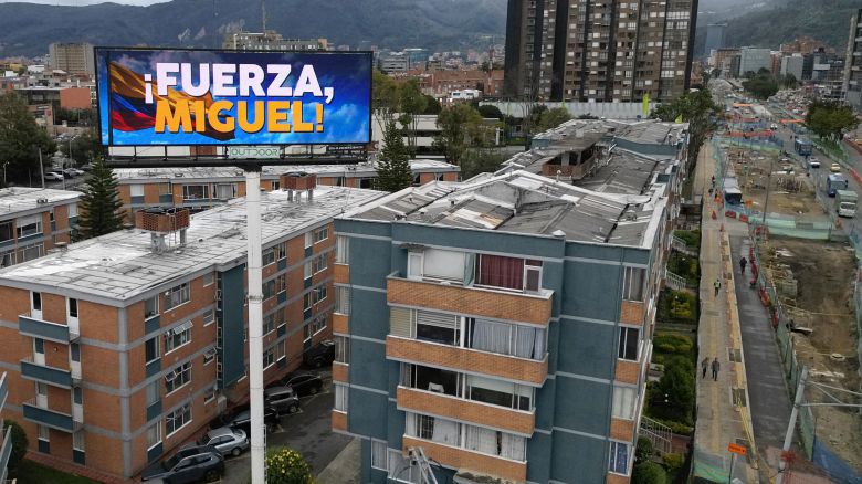 An aerial view shows a billboard reading "Strength Miguel" in  of Senator Miguel Uribe Turbay, who was shot and wounded during a political event on Saturday, in Bogota, on June 10, 2025. Right-wing senator and presidential candidate Miguel Uribe is in intensive care, and his condition is stable but critical, according to the latest medical report. (Photo by Raul ARBOLEDA / AFP) (Photo by RAUL ARBOLEDA/AFP via Getty Images)          
