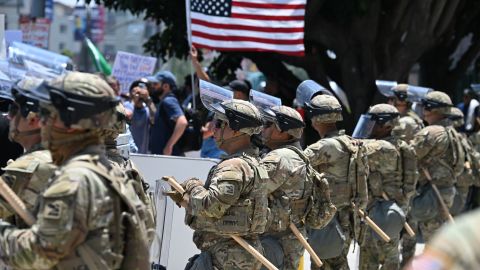 of the California National Guard form a line near the entrance to a federal building's loading dock and parking garage, where a small group of protesters gathers amid ongoing demonstrations in response to federal immigration operations, on June 10, 2025, in downtown Los Angeles. US President Donald Trump on June 10 claimed Los Angeles was being invaded by a "foreign enemy" and vowed to "liberate" the city after days of protests sparked by immigration raids. Trump has deployed thousands of troops including 700 active duty US Marines to Los Angeles, despite California authorities saying the move is unnecessary and will inflame the situation. (Photo by Robyn Beck / AFP) (Photo by ROBYN BECK/AFP via Getty Images)          