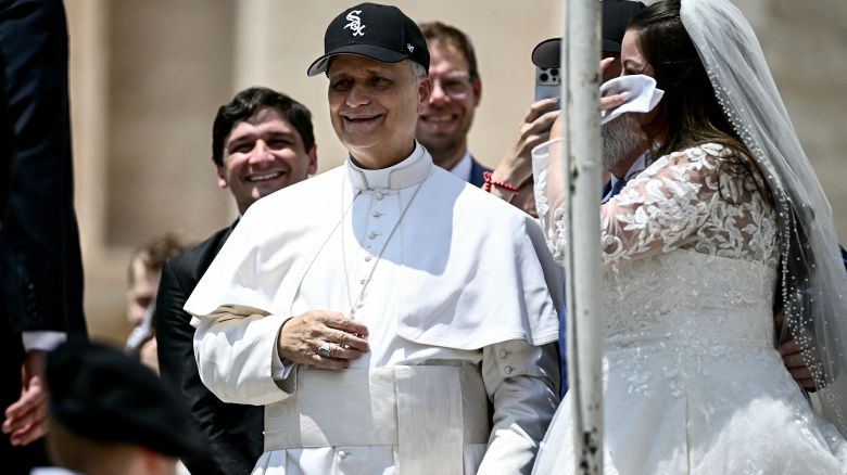 Pope Leo XIV (C) reacts wearing a Chicago White Sox baseball team cap as he meets newly wedded couples during the weekly general audience in St Peter's Square at the Vatican on June 11, 2025. (Photo by Filippo MONTEFORTE / AFP) (Photo by FILIPPO MONTEFORTE/AFP via Getty Images)          