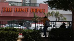 People wait outside of a Home Depot store on Wilshire Blvd that was previously the site of Immigration and Customs Enforcement (ICE) detention of day laborers in the Westlake MacArthur Park neighborhood of Los Angeles, California, on June 11, 2025. Protests against Donald Trump's harsh immigration policies spread on June 11 across the United States despite a military-backed crackdown in Los Angeles and a threat by the Republican president to use "heavy force." In Los Angeles, where the unrest began, an overnight curfew in the downtown area saw police make 25 arrests by morning.