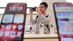 A customer tries a new Huawei phone in its Global Flagship Store in Shanghai, China this month.