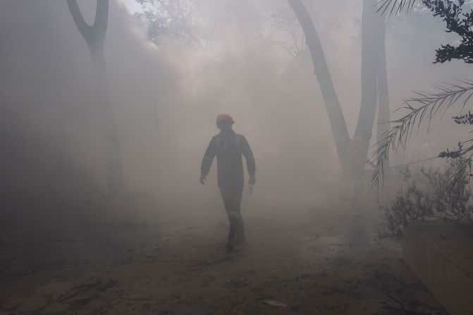 A firefighter works at the crash site.
