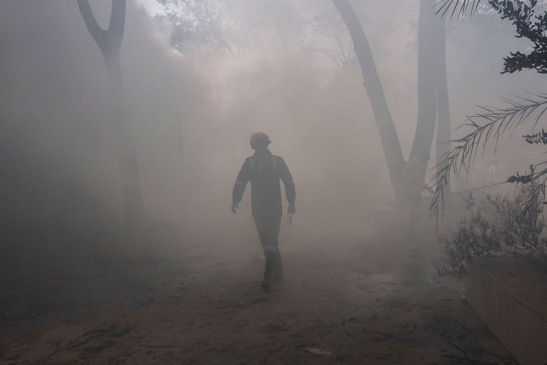 A firefighter works at the site where Air India flight 171 crashed in a residential area near the airport in Ahmedabad on June 12, 2025.