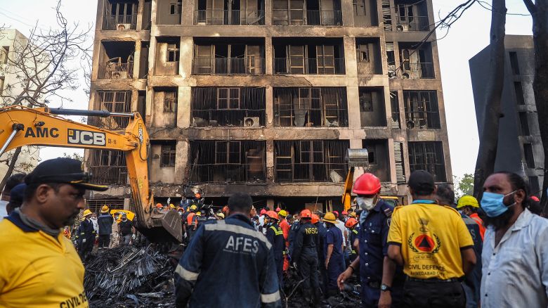 Rescue officials work at the site where Air India flight 171 crashed in a residential area near the airport in Ahmedabad on June 12, 2025. A London-bound passenger plane crashed in the Indian city of Ahmedabad on June 12 and all 242 people on board were believed killed, with the jet smashing into buildings housing doctors and their families.