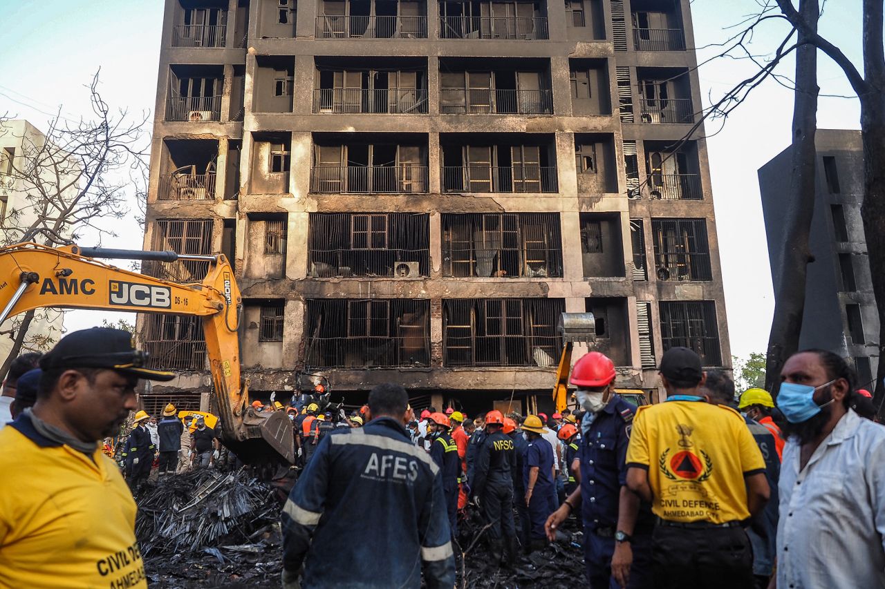 Rescue officials work at the site where Air India flight 171 crashed in a residential area near the airport in Ahmedabad today.