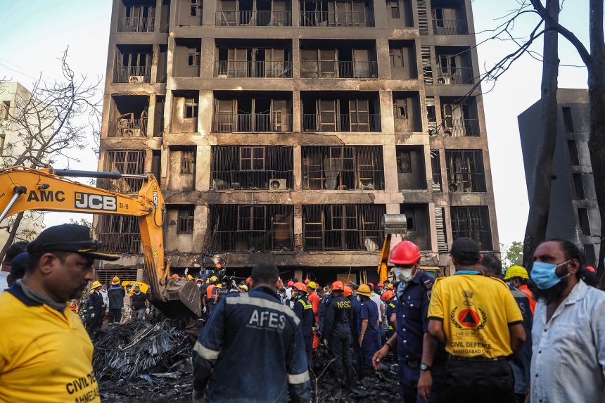 Rescue officials work at the site where an Air India flight crashed in a residential area near the airport in Ahmedabad on June 12, 2025. Investigators have found black boxes from the flight.