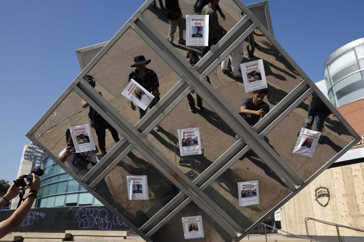 Pictures of people arrested by ICE hang on a sculpture in Little Tokyo in Los Angeles, on Thursday, June 12.