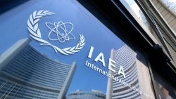 Buildings of the International Atomic Energy Agency (IAEA) headquarters reflect in doors with the agency's logo during the IAEA's Board of Governors meeting in Vienna, Austria on June 13, 2025, where the IAEA's head Rafael Grossi briefed board members following Israeli strikes on Iran, including on the Natanz uranium enrichment facility. (Photo by Joe Klamar / AFP) (Photo by JOE KLAMAR/AFP via Getty Images)          