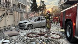 First-responders gather outside a building that was hit by an Israeli strike in Tehran on June 13, 2025. Israel hit about 100 targets in Iran on June 13, including nuclear facilities and military command centres and killing senior figures including the armed forces chief and top nuclear scientists. (Photo by MEGHDAD MADADI / TASNIM NEWS / AFP) (Photo by MEGHDAD MADADI/TASNIM NEWS/AFP via Getty Images)          