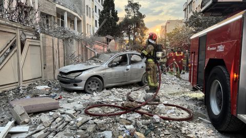First-responders gather outside a building that was hit by an Israeli strike in Tehran on June 13, 2025. Israel hit about 100 targets in Iran on June 13, including nuclear facilities and military command centres and killing senior figures including the armed forces chief and top nuclear scientists. (Photo by MEGHDAD MADADI / TASNIM NEWS / AFP) (Photo by MEGHDAD MADADI/TASNIM NEWS/AFP via Getty Images)          