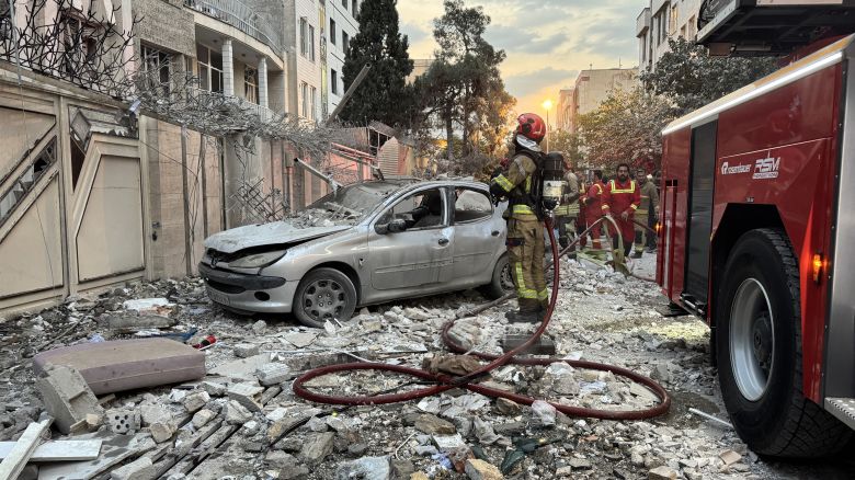 First-responders gather outside a building that was hit by an Israeli strike in Tehran on June 13, 2025. Israel hit about 100 targets in Iran on June 13, including nuclear facilities and military command centres and killing senior figures including the armed forces chief and top nuclear scientists. (Photo by MEGHDAD MADADI / TASNIM NEWS / AFP) (Photo by MEGHDAD MADADI/TASNIM NEWS/AFP via Getty Images)          