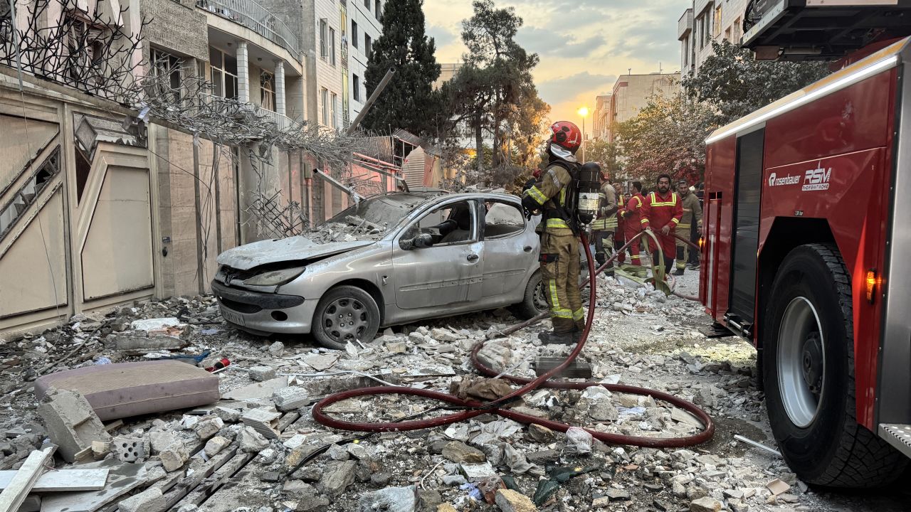 First-responders gather outside a building that was hit by an Israeli strike in Tehran on June 13, 2025. Israel hit about 100 targets in Iran on June 13, including nuclear facilities and military command centres and killing senior figures including the armed forces chief and top nuclear scientists. (Photo by MEGHDAD MADADI / TASNIM NEWS / AFP) (Photo by MEGHDAD MADADI/TASNIM NEWS/AFP via Getty Images)          