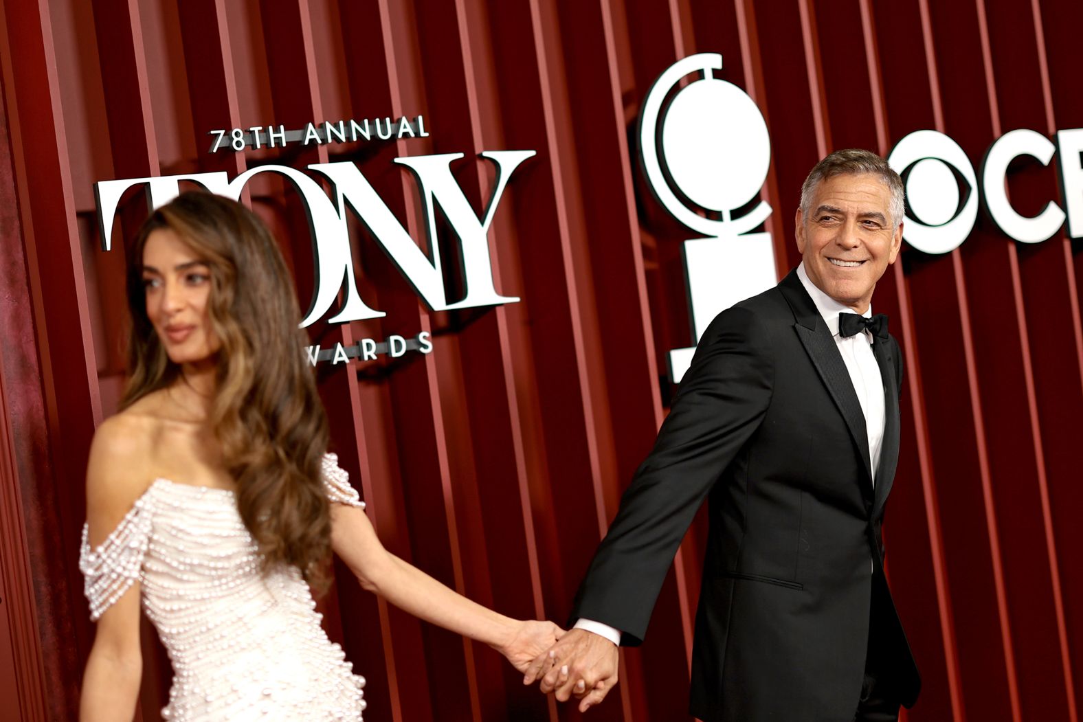 Amal Clooney and George Clooney walk the red carpet.