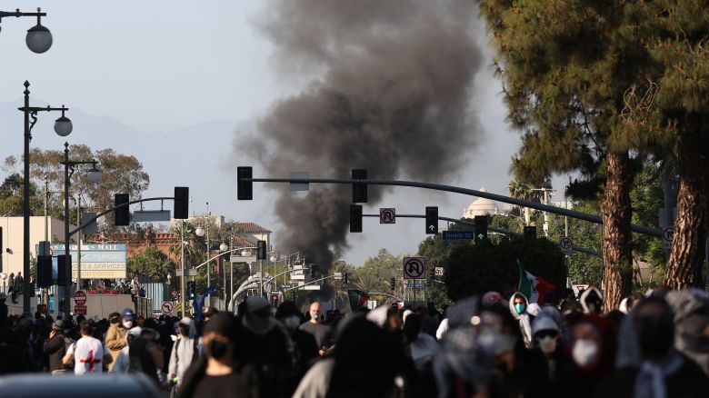 LOS ANGELES, LOS ANGELES - JUNE 08: Smoke is seen as LAPD officers clear protestors who were blocking the 101 freeway on June 08, 2025 in Los Angeles, California. Tensions in the city remain high after the Trump istration called in the National Guard against the wishes of city leaders following two days of clashes with police during a series of immigration raids. More protests are scheduled for today. (Photo by Jim Vondruska/Getty Images)