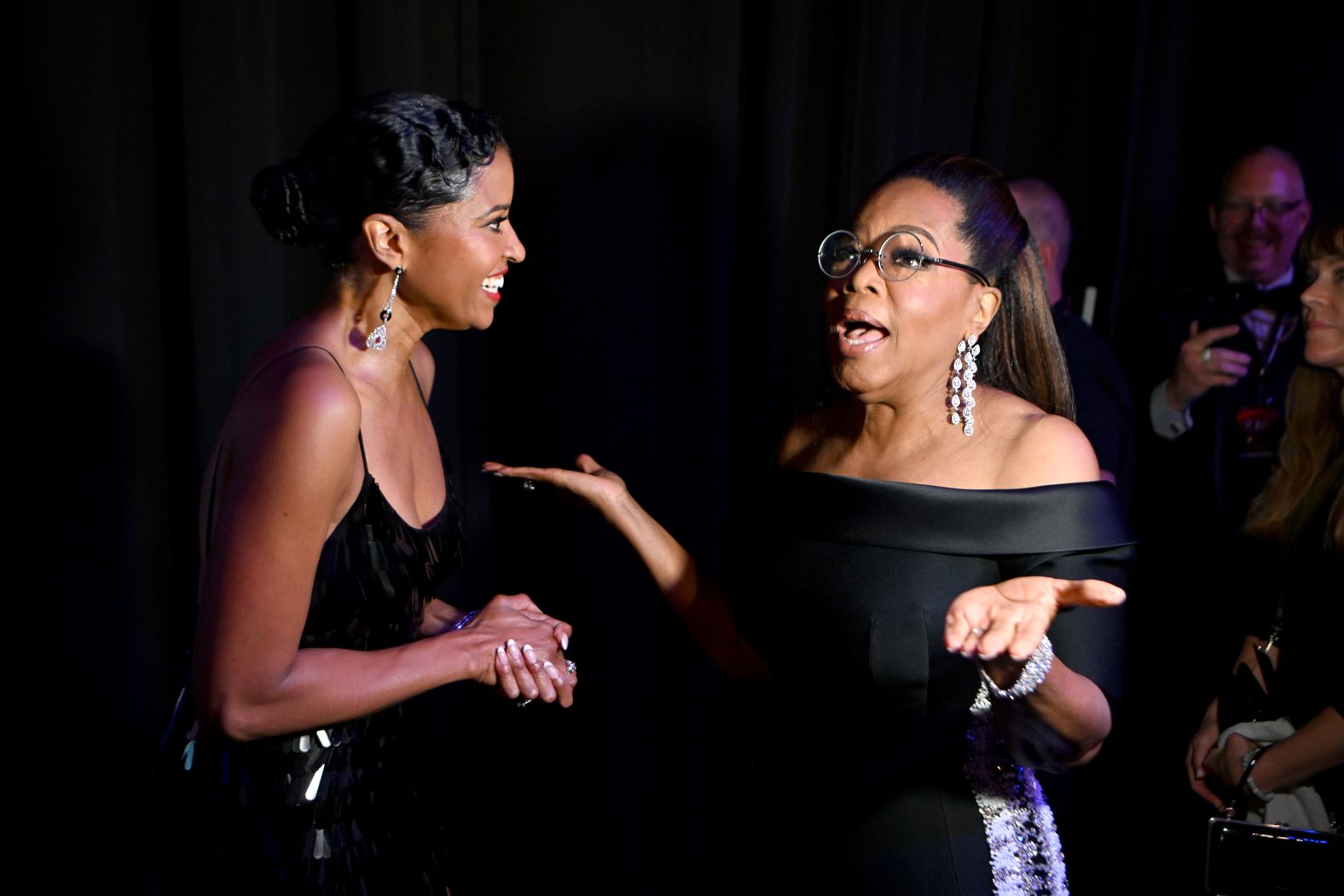 Renee Elise Goldsberry, left, and Oprah Winfrey speak backstage.