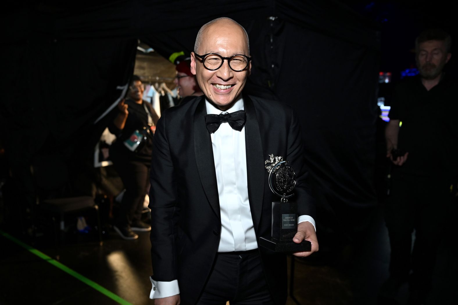 Francis Jue poses with his award for best performance by a featured actor in a play for "Yellow Face."