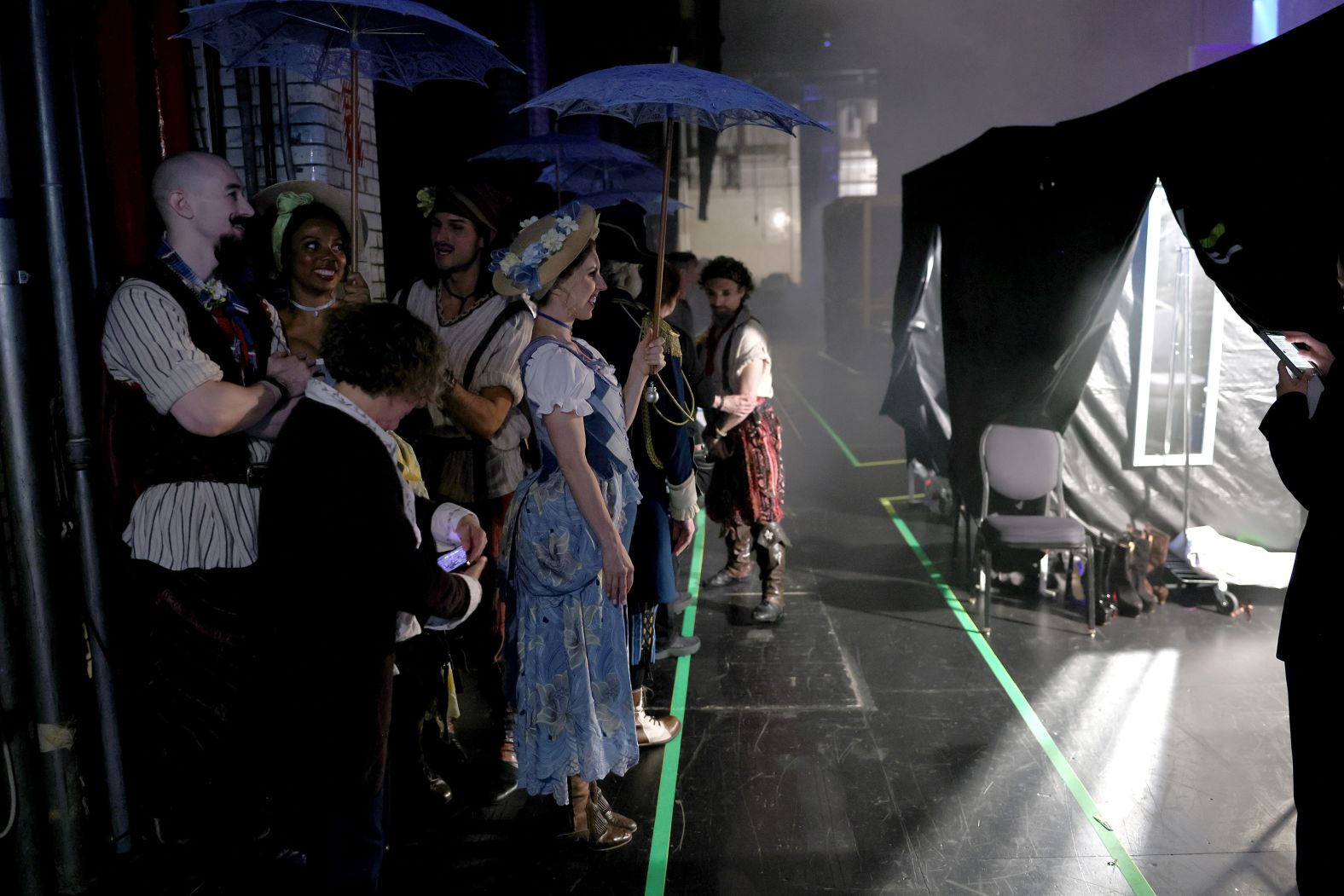 The cast of "Pirates! The Penzance Musical" stand backstage.