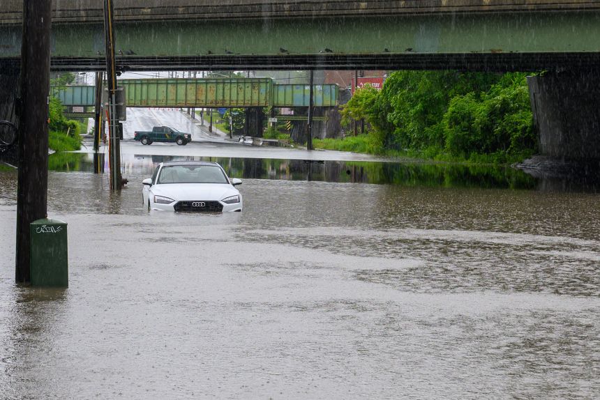 A white Audi got stuck when Central Avenue flooded under the I-90 overpass on Saturday, June 7, 2025 in Albany, New York.