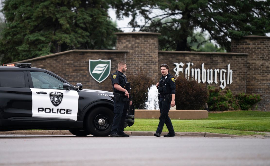 Brooklyn Park police officers guard the entrance to a neighborhood in Minnesota on Saturday.