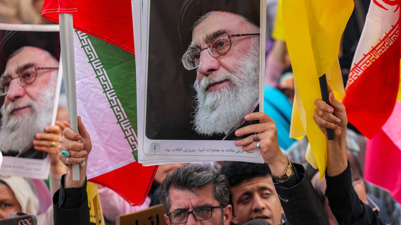 A demonstrator holds a picture of Iran's Supreme Leader Ayatollah Ali Khamenei while gathering with others during a rally in solidarity with the government against Israel's attacks on Iran and to mark Eid al-Ghadir, when according to Shiite Muslim belief the Islamic prophet Mohamed designated his nephew and companion Ali ibn Abi Talib as his successor, at Enghelab (Revolution) Square in Tehran on June 14, 2025. (Photo by ATTA KENARE / AFP) (Photo by ATTA KENARE/AFP via Getty Images)          