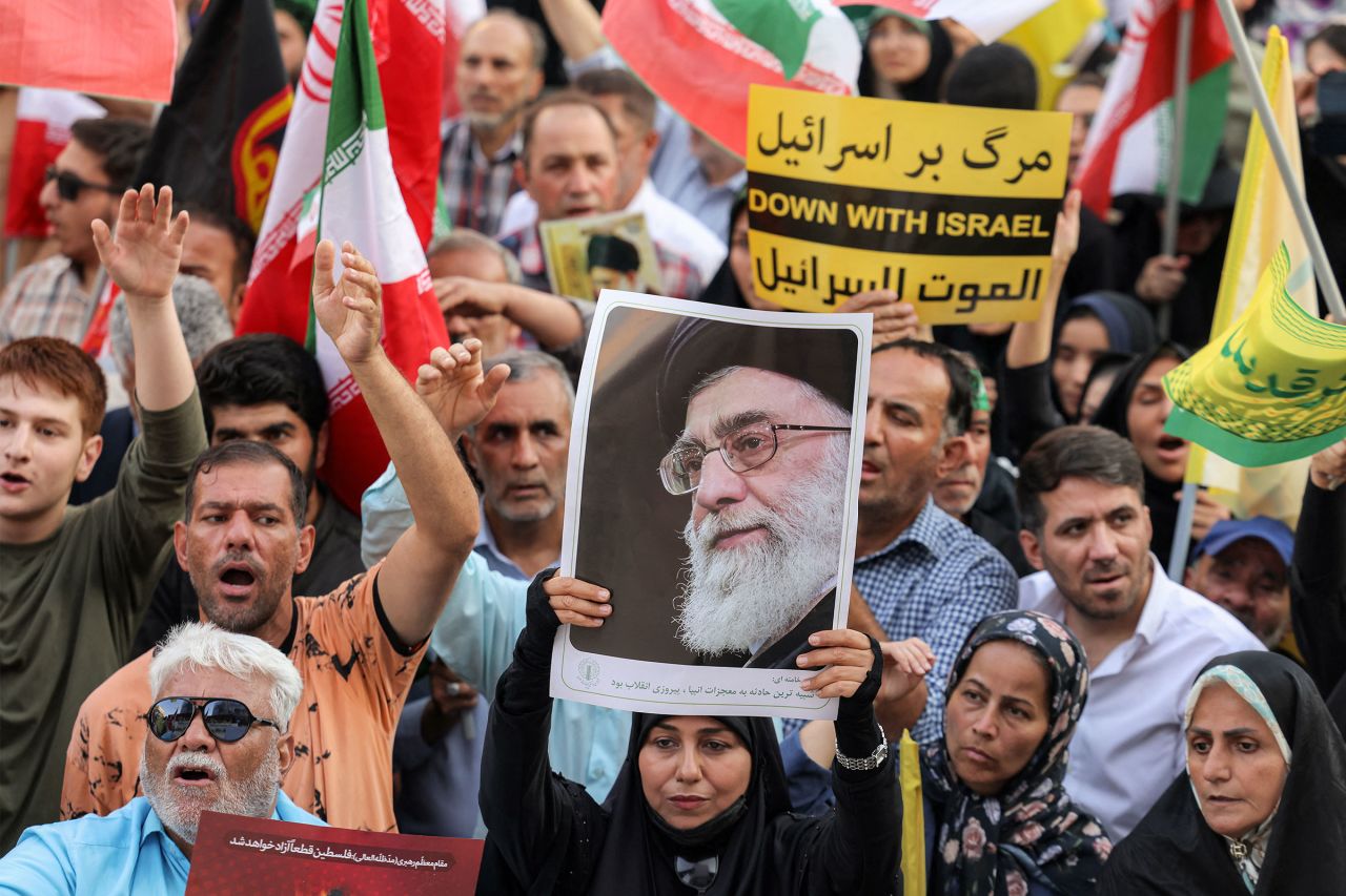 A demonstrator holds a picture of Iran's Supreme Leader Ayatollah Ali Khamenei during a rally against Israel's attacks on Iran, at Enghelab Square in Tehran on June 14.