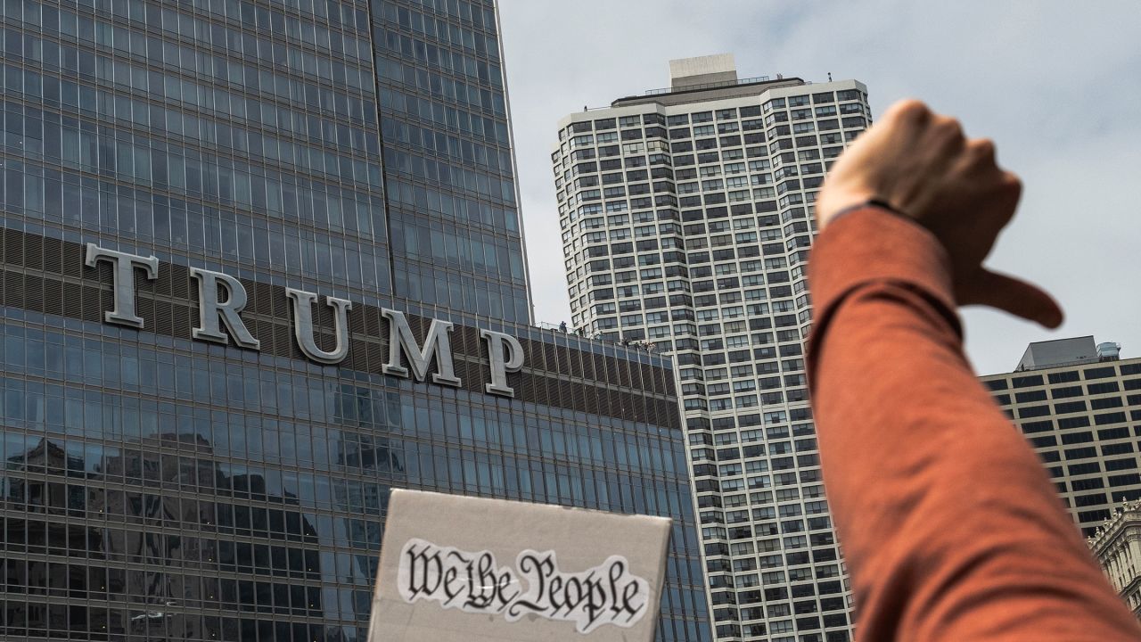 CHICAGO, ILLINOIS - JUNE 14: Protesters give a thumbs down gesture while march through the past Trump tower as part of a nation wide "No Kings" demonstration on June 14, 2025 in Chicago, Illinois. Hundreds of marches and protests against the Trump administration are happening across the United States today in opposition to Trump's presidency as well as the military parade celebrating the 250th anniversary of the U.S. Army taking place in Washington, DC. Today's parade coincides with President Trump's birthday. (Photo by Jim Vondruska/Getty Images)
