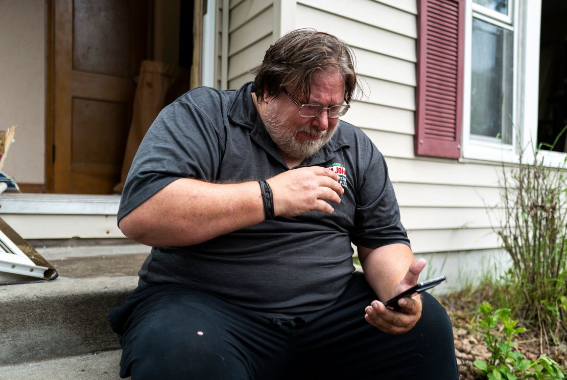 David Carlson reads a text message outside his home on June 14, 2025, in Minneapolis, Minnesota.