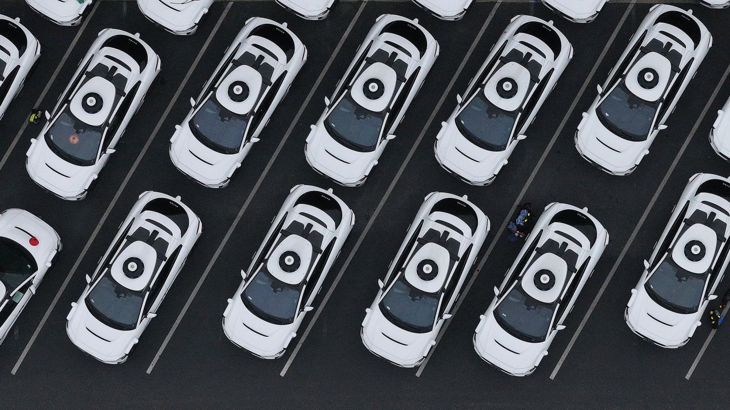 In an aerial view, Waymo cars are seen parked at a Waymo facility in San Francisco, California. Waymo is providing paid rides already in four cities, including San Francisco. It is starting tests in New York City, but not yet providing rides there.