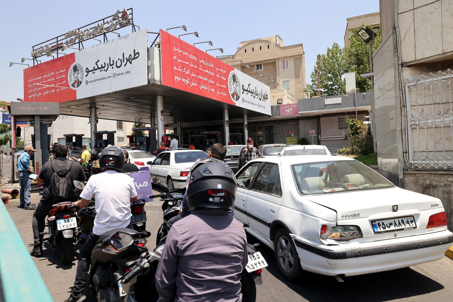 Motorists queue at a petrol station in Tehran after overnight Israeli missile strikes hit multiple fuel depots in the area.