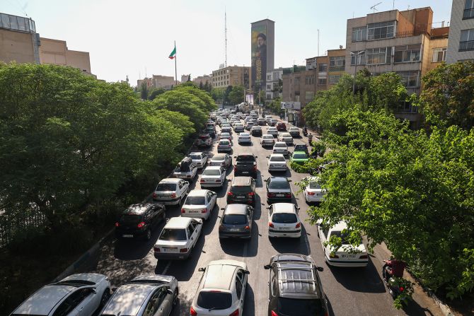 Traffic builds as people flee Tehran on Sunday.