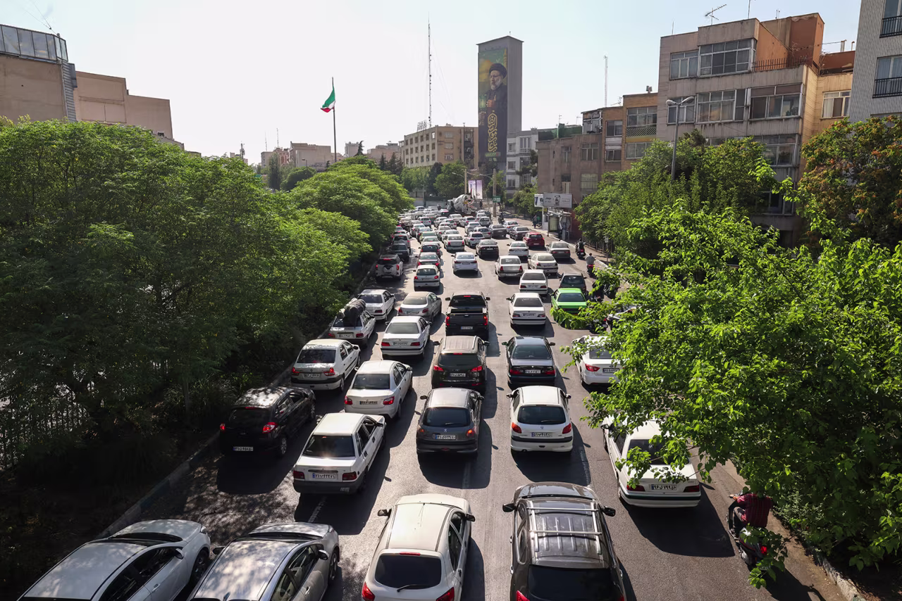 Vehicles await in traffic as people get out of Tehran on Sunday.
