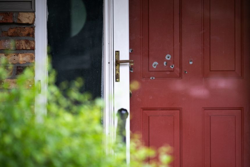 Bullet holes are seen in the door outside the home of State Sen. John Hoffman in Champlin, Minnesota, on June 15.