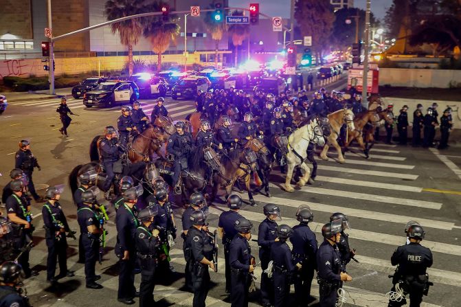 Police move to enforce an 8 p.m. curfew in downtown Los Angeles, after it went into effect on Tuesday, June 10. Mayor Karen Bass <a href="https://www.cnn.com/us/live-news/la-protests-ice-raids-trump-06-11-25#cmbravjug001w26pa23t08ryw">declared a curfew for the 1 square mile</a> in which protests have been centered.