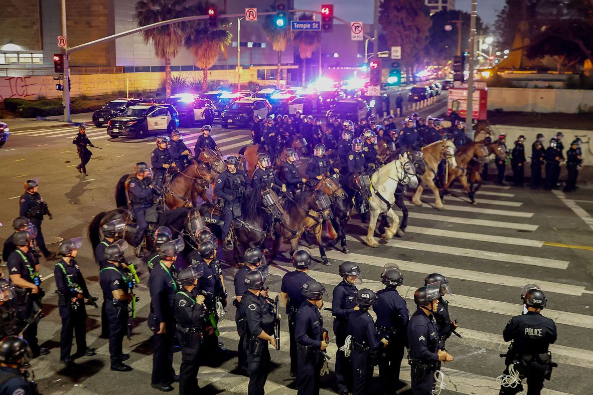 Police move to enforce an 8 p.m. curfew in downtown Los Angeles, after it went into effect on Tuesday, June 10. Mayor Karen Bass <a  target="_top" href="/newspapers?url=https://www.cnn.com/us/live-news/la-protests-ice-raids-trump-06-11-25#cmbravjug001w26pa23t08ryw">declared a curfew for the 1 square mile</a> in which protests have been centered.