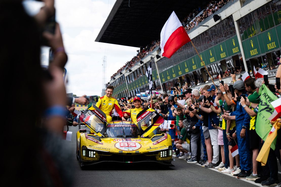 Race winners Robert Kubica (driving), Yifei Ye (right) and Philip Hanson celebrate at the end of Le Mans.
