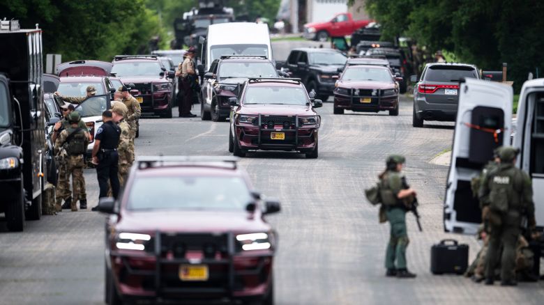 GREEN ISLE, MINNESOTA - JUNE 15: Law enforcement stage in a neighborhood on June 15, 2025 in Green Isle, Minnesota. Law enforcement agencies are searching for a suspect in the killing of DFL State Rep. Melissa Hortman and her husband, Mark Hortman, who were shot at their home yesterday. DFL State Sen. John Hoffman and his wife were also shot and hospitalized in a separate incident. Minnesota Gov. Tim Walz said during a press conference that the shooting "appears to be a politically motivated assassination." (Photo by Stephen Maturen/Getty Images)